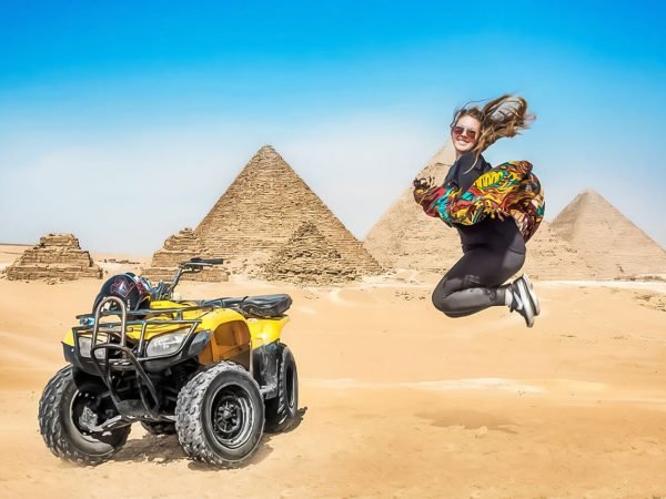 A-wonderful-shot-of-a-tourist-with-a-quad-bike-in-front-of-the-Pyramids-of-Giza
