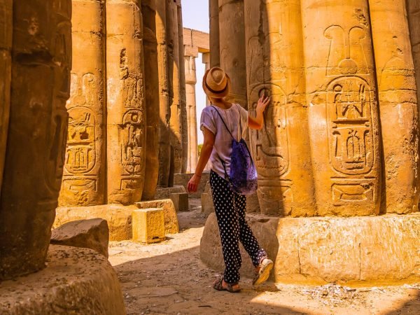 A-tourist-near-one-of-the-columns-of-Karnak-Temple