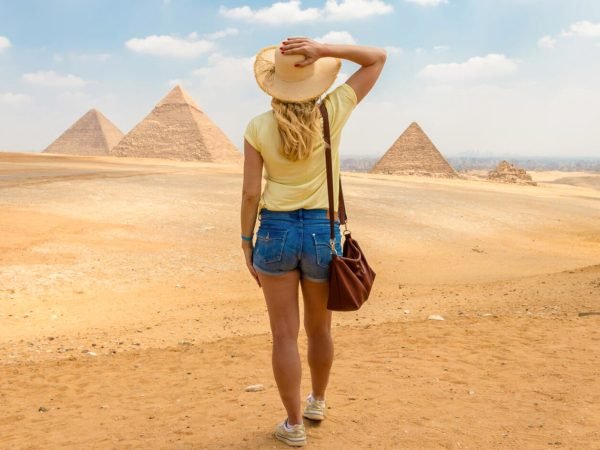 A-great-shot-of-a-solo-female-traveler-in-front-of-the-pyramids